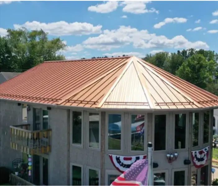 Tarping and dry-in on a Sand Creek Woods commercial roof
